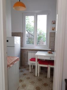 a kitchen with a white table and a white refrigerator at Gianna's cosy apartment in Monterosso al Mare