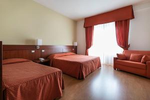 A bed or beds in a room at Hotel Conradi