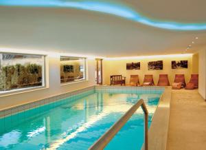 a large swimming pool in a house at Schwarzwaldhotel Klumpp in Baiersbronn
