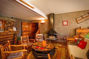 a living room with a table and a fireplace at Hôtel & Spa La Ferme de l'Izoard in Arvieux