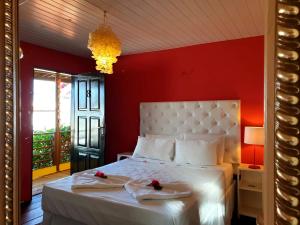 a bedroom with a white bed with two towels on it at Pousada Duna Beach in Jericoacoara