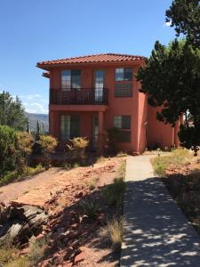 a red house on a hill with a pathway at The Penrose Bed & Breakfast in Sedona