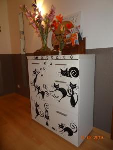 a white dresser with black cats on it at LE KATZALA in Mulhouse
