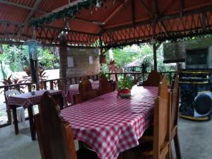 a table with a red and white checkered table cloth at Enna's Place in Coron
