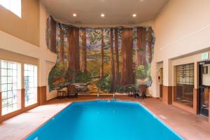 a swimming pool in a room with a painting on the wall at The Redwood Riverwalk, a boutique hotel in Fortuna