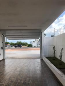 an empty parking garage with a car in the background at GRAN PARADA HOTEL in Castanhal