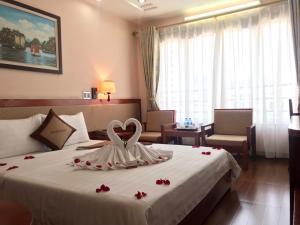 a hotel room with a bed with a heart on it at Paradis Hotel in Ha Long