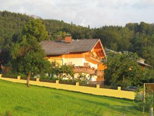 a large house in the middle of a field at Gästehaus Horizont in Mondsee