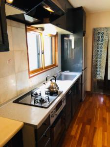 a kitchen with a stove with a tea kettle on it at Apartment at Toemu Nozawa in Nozawa Onsen