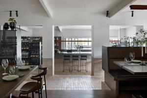 a dining room with a bar with stools at Polperro Farmhouse in Red Hill