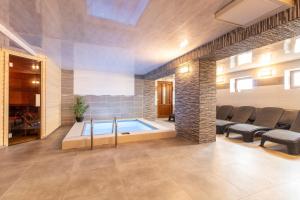 a large room with a swimming pool in a house at Restaurace penzion Pod Šumárníkem in Tvarožná Lhota