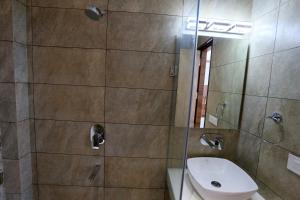 a bathroom with a shower and a toilet and a sink at A Palace on River ( Rashmi Guest House ) in Varanasi