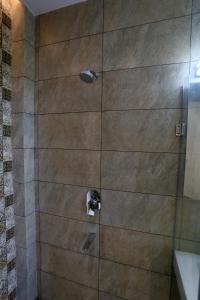 a shower with two faucets in a bathroom at A Palace on River ( Rashmi Guest House ) in Varanasi