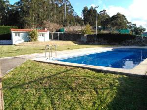 a swimming pool in the yard of a house at Apartamento Covelo in Poio