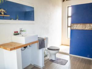 La salle de bains est pourvue d'un lavabo blanc et de toilettes. dans l'établissement Casa Narinho, à Praia do Tofo