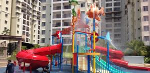 a playground with a water slide in a city at 3 Bedrooms at Lagoon Park Resort in Melaka +8 photos