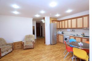 a kitchen with a table and chairs and a dining room at Top Apartments - Yerevan Centre in Yerevan