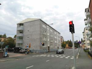 a red traffic light on a street with a building at HomeAway City in Kuopio