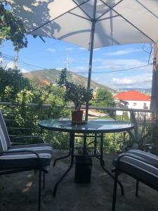 a table with a potted plant and an umbrella at Apartment Lui in Tbilisi City