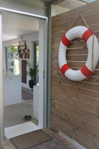 a red and white life preserver hanging on a wall at WategosRent in Byron Bay