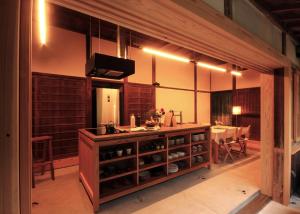 a kitchen with a counter and a table with chairs at HÏSOM in Ōda