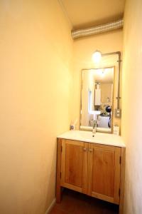 a bathroom with a sink and a mirror at kODATEL コダテル 札幌大通公園 アネックス in Sapporo