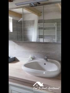 a bathroom with a white sink and a mirror at ‘Feel So Good’ apartment in Göd +27 photos