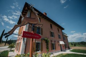 una señal frente a un edificio con un caballo. en Casale in Collina en Capriva del Friuli