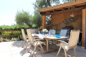 a wooden table and chairs on a patio at Villa Mediterranea in Calonge
