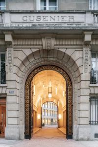 une entrée à un bâtiment avec un panneau sur celui-ci dans l'établissement Deskopolitan House, à Paris