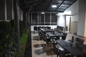 a row of tables and chairs in a restaurant at Heritage Inn in Mysore