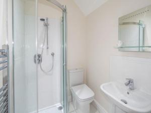a bathroom with a shower and a toilet and a sink at Pinley Hill House in Warwick