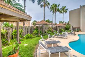 a patio with chairs and a pool at a resort at Surfside Condos in South Padre Island