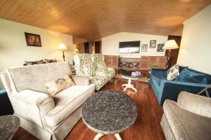 a living room with couches and a table at Holiday In Homestay in Shimla