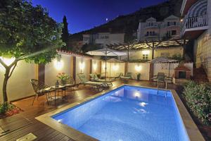 a swimming pool on a deck next to a house at Villa Gloria in Dubrovnik