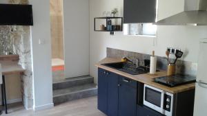 a kitchen with a sink and a counter top at Le gîte de la Mane in Saint-Pierre-dʼAurillac