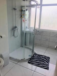 a bathroom with a shower and a black and white rug at Old Palace Budget Rooms 21PP in Norwich