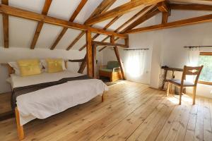 a bedroom with a bed and a desk in a room at Старата къща - Трявна in Tryavna