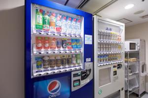 a vending machine filled with lots of bottles of soda at Hotel Sardonyx Ueno in Tokyo
