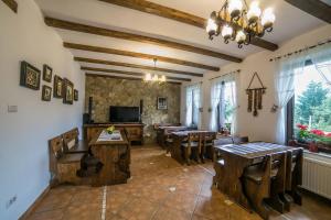 a dining room with wooden tables and chairs at Casa Verde in Voronet