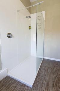 a shower with a glass door in a bathroom at Station Hotel in Thurso