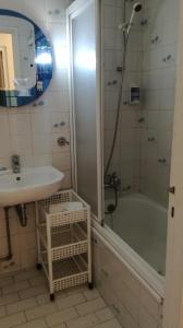 a bathroom with a sink and a tub and a shower at Hotel Mira D'Aire in Porto +55 photos