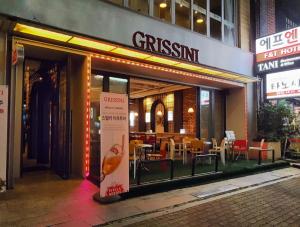 a restaurant with tables and chairs outside of it at BOLTON Hotel in Gwangju