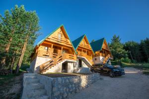 a house with a car parked in front of it at Paradise Zabljak in Žabljak