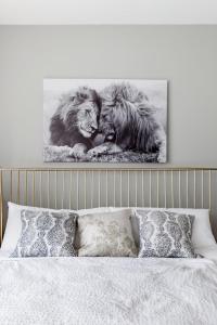 two lions sitting next to each other on a bed at Trendy Castleberry Hill Condo- Walk to Mercedes Benz/ All Downtown Attractions in Atlanta