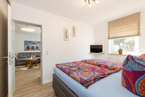 a bedroom with a bed and a living room at Ferienwohnung Ulber in Westerland