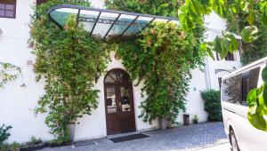 a white building with a brown door with flowers at Hotel Nippon Colombo in Colombo