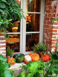 a group of pumpkins sitting in front of a window at La Cour Sainte Catherine demeure de charme in Honfleur