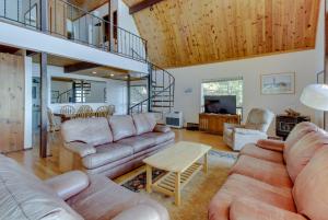 a living room with a couch and a table at Lopez Island Hunter Bay Waterfront Home in Lopez