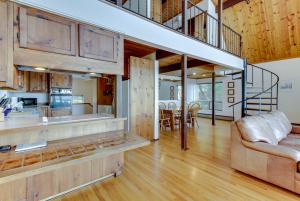 an open kitchen and living room with a staircase in a house at Lopez Island Hunter Bay Waterfront Home in Lopez